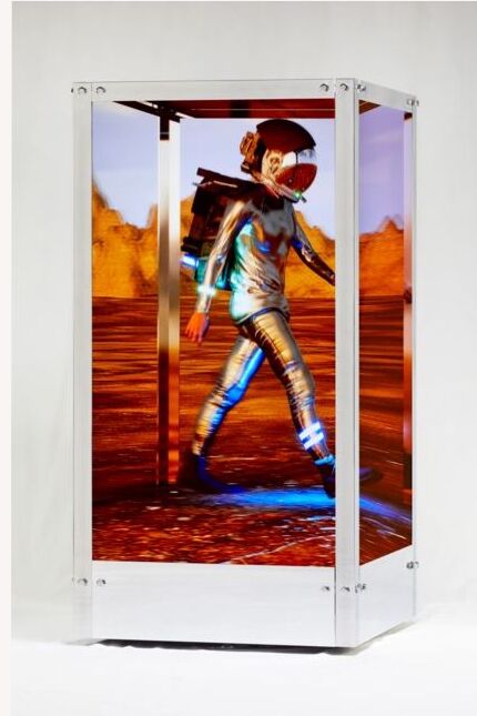 HUMAN ONE, a walking figure across the screens of a freestanding sculpture