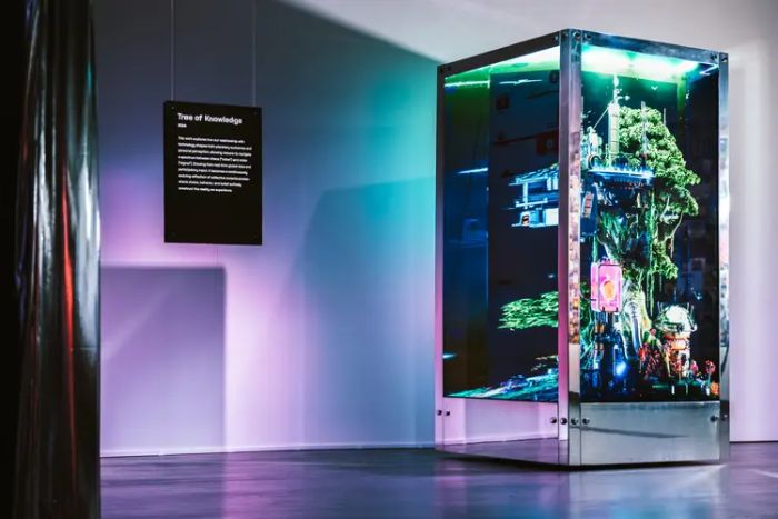 Tree of Knowledge on view with illuminated screens and exhibition wall text